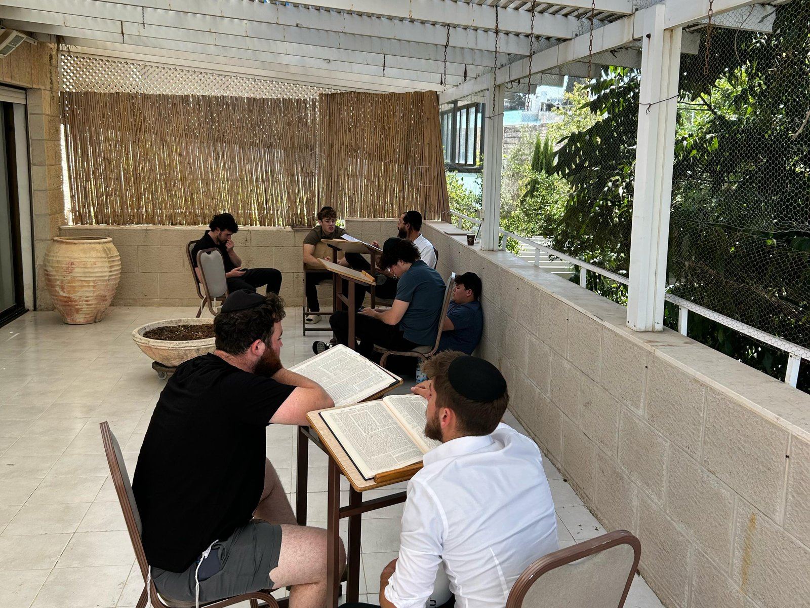 Talmidim learning together on the patio