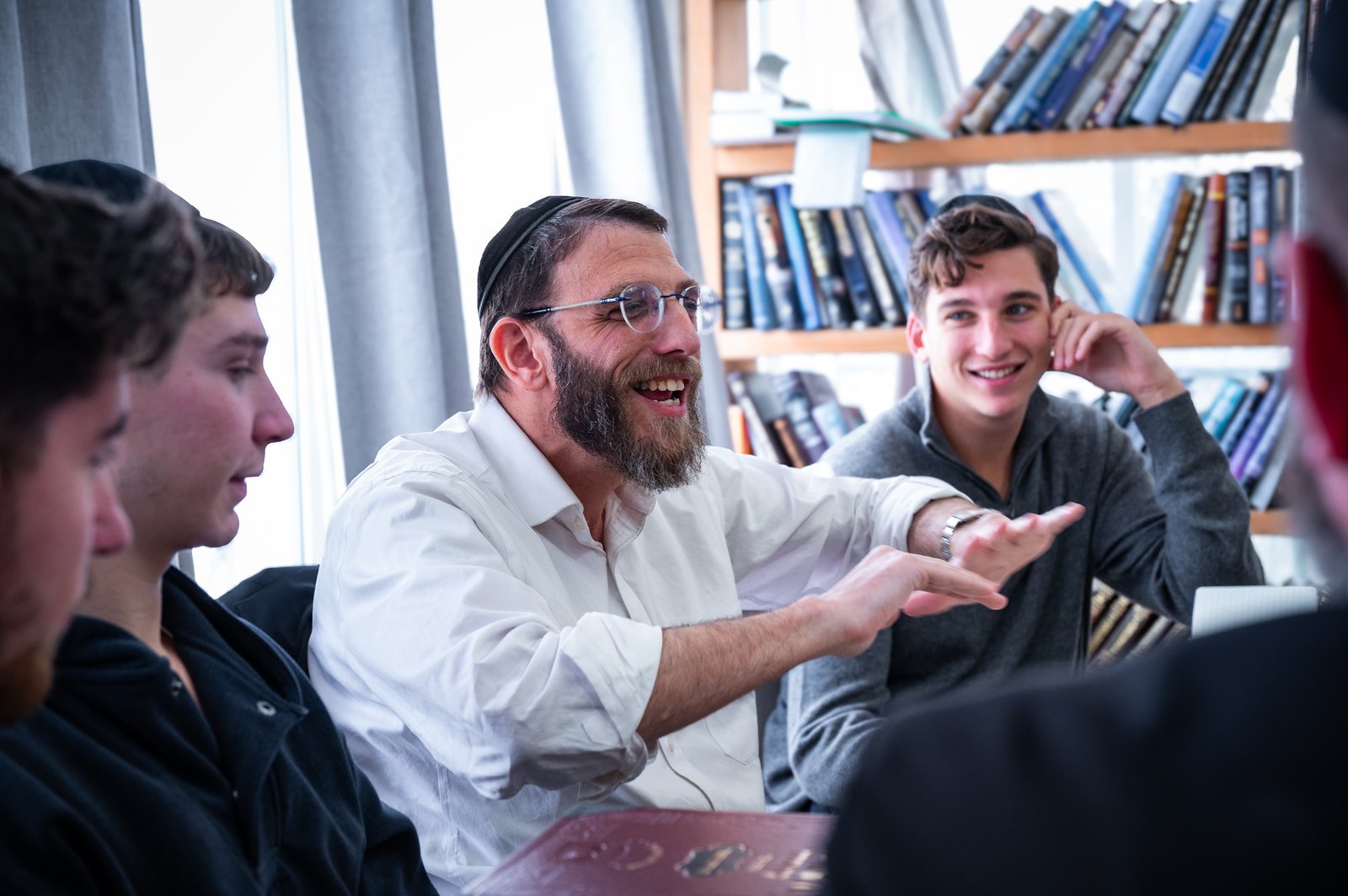 A rebbi laughing with talmidim in the beis medrash