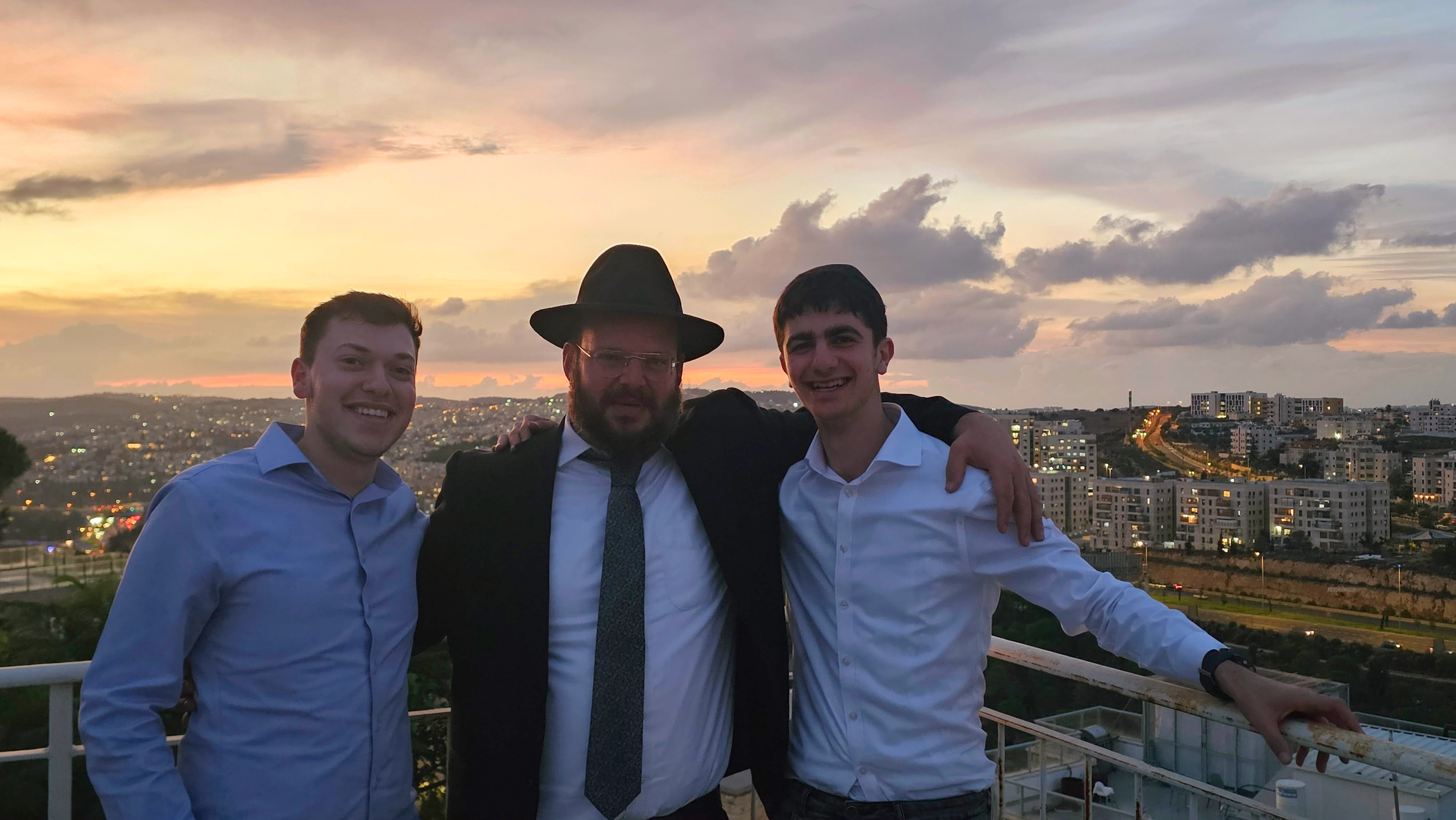 Two talmidim with a Rebbi at sunset